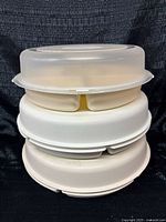 Stacked view showing three trays and lid