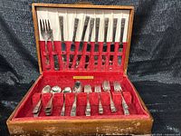 Open case showing all flatware pieces in velvet-lined interior