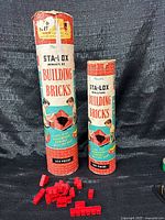 Two Sta-Lox canisters with loose red bricks in front