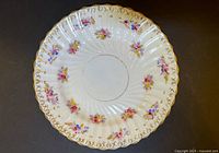 Front view of plate showing floral decoration and gold rim