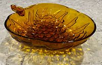 Side profile of amber glass grape-shaped bowl
