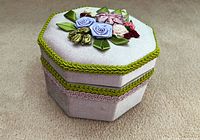 Closed hexagonal jewelry box showing ribbon embroidery and trim