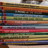 Stack of 13 Disney Wonderful World of Reading books showing all spines and titles