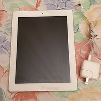White-bezel iPad 2 with charger and cable