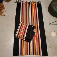 Both rugs displayed, one spread out, one folded