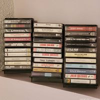 Three vertical racks of cassette tapes displayed side-by-side showing most titles