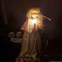 Animated angel doll lit and swaying in low light