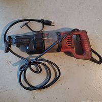 Full view of Milwaukee corded reciprocating saw with blade taped to side