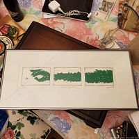 Full view of framed print showing three panels, frame, cracked glass