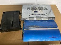 Overview of all three amplifiers: black Kenwood, silver Audiobahn, blue Profile California