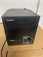 Front view of Aiwa powered subwoofer showing logo, port and overall cabinet