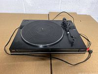 Top view of Fisher MT-857 turntable showing platter, tonearm and cables