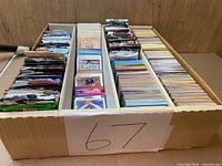 Top view of entire box showing loose cards in right channel and sealed packs in left and center channels
