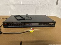 Front view of Fisher FM-270 tuner with attached RCA cable