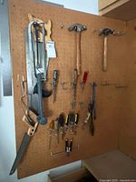 Pegboard with saw, clamp, hammers, screwdrivers, chisels