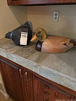 Both duck figurines on countertop