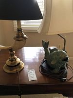 Ram horn lamp and fish lamp side by side on table