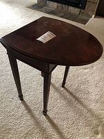 Three-quarter view of table with leaf folded, showing overall form