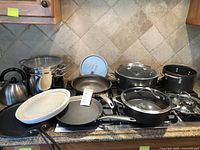 Full group of cookware on stovetop