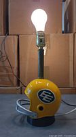 Lamp overall lit with bulb showing helmet base and lamp column