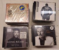 Four CDs: Sarah Vaughan (sealed), Bobby Brown, Lionel Richie, Gordon Lightfoot