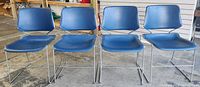 Front view of four blue Kruger Matrix chairs on metal sled bases