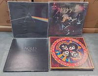 Four album covers: Pink Floyd The Dark Side of the Moon, KISS Alive!, Eagles The Long Run, KISS Rock and Roll Over