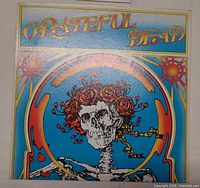 Front gatefold album cover with skeleton and roses artwork