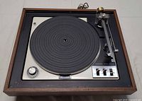 Top view showing complete turntable with wood plinth, platter, tonearm and controls