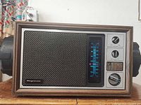 Front view showing speaker grille, tuning dial, and controls