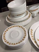 Stacked bowls on top of salad and dinner plates with cup edge visible