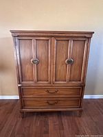 Front view of wooden dresser with cabinet doors and drawers