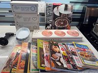 All boxed items, bread tubes, bake pan set, copper molds, cookbooks displayed