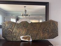 Full frontal view of embossed metal Last Supper wall art on wood backing