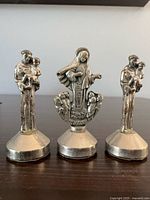 Front view of three metal magnetic statues