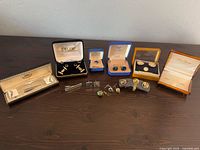 All boxed sets and loose cufflinks displayed on table