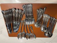 All flatware pieces laid out showing quantity and ornate pattern