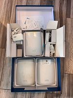 Opened retail box showing all three Orbi units, power adapters, cable and paperwork