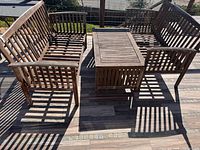 Overall view of two benches and table on deck