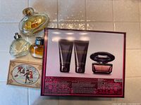 Overall lot showing three perfume bottles, Versace gift set box and Avon soap box