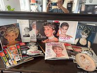 Group shot of all magazines, books, calendars and plate