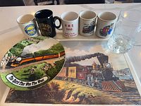 Group shot showing all mugs, plate, placemat and glass stein