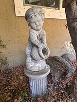 Front view of statue on pedestal showing full figure and base