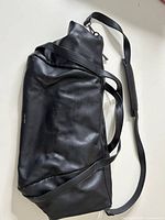 Full view of black Pixie Mood weekender bag with handles and shoulder strap