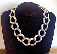 Full view of silver-tone chunky chain necklace displayed on bust