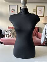 Front view of black female torso mannequin showing neck finial and overall condition