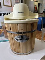 Front view of ice cream maker showing wood bucket and motorized lid