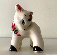 Front view of white ceramic deer planter with floral paint and crackle glaze