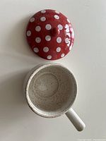 Top view of brie baker showing open base and detached red polka-dot lid