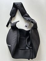 Overall view of the black Allgoods pet sling carrier showing shape, shoulder strap and drawstring opening